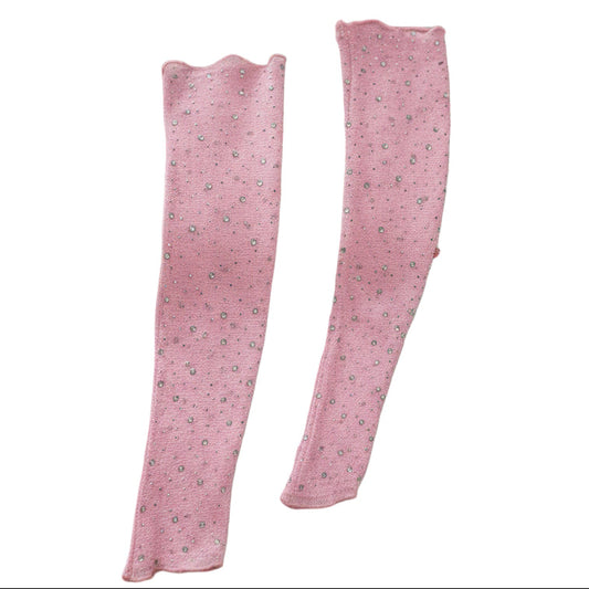 pink fingherless gloves on a girls bed