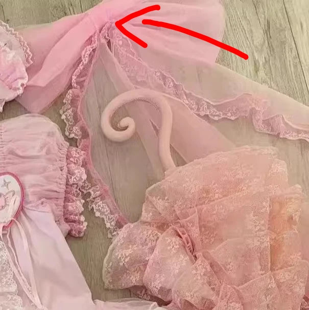 Pink lace headband with decorative elements on a wooden surface