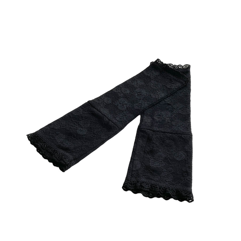 A pair of black lace fingerless gloves placed on a white background