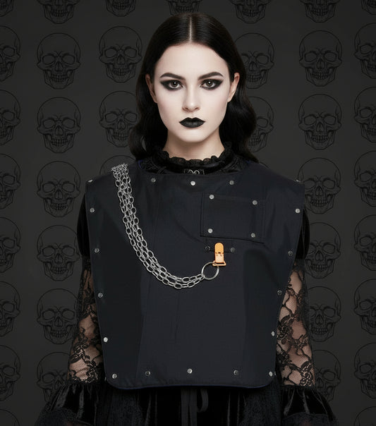Black adult sized bib with metal studs and chain on a goth girl in front of black skulls