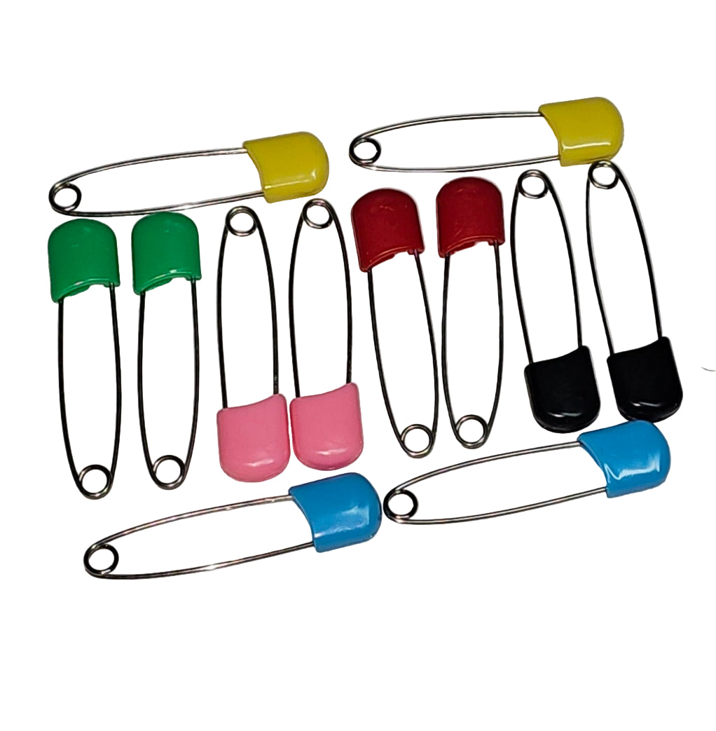 Colorful safety pins on a gray background