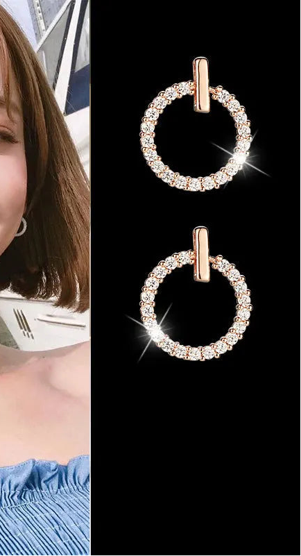 Woman wearing hoop earrings with a close-up of the earrings on a black background.