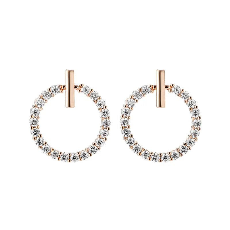 Pair of hoop earrings with rose gold and clear gemstones on a white background