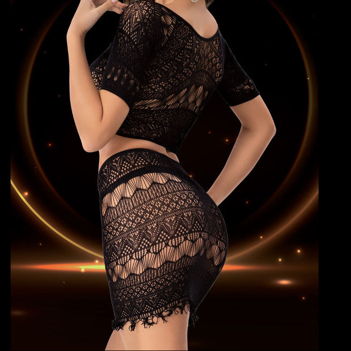 Woman wearing a black lace outfit against a dark background with a glowing circular design.