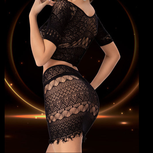 Woman wearing a black lace outfit against a dark background with a glowing circular design.