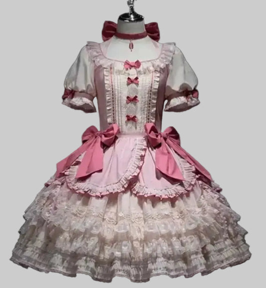 Lace dress with pink bows on a mannequin against a black background, branded 'Irelia H Store'.