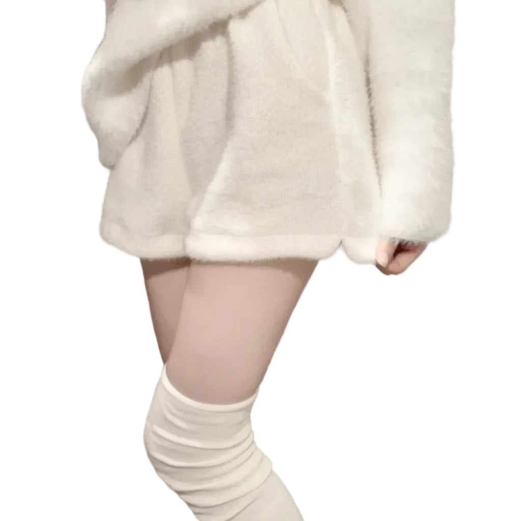 Person wearing a white fluffy coat and knee-high white socks in a room with a coat rack.