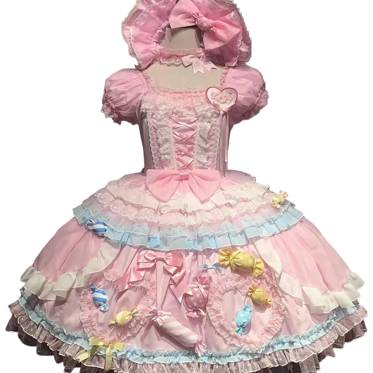 Pink and blue dress with ruffles and bows on a mannequin against a dark background.