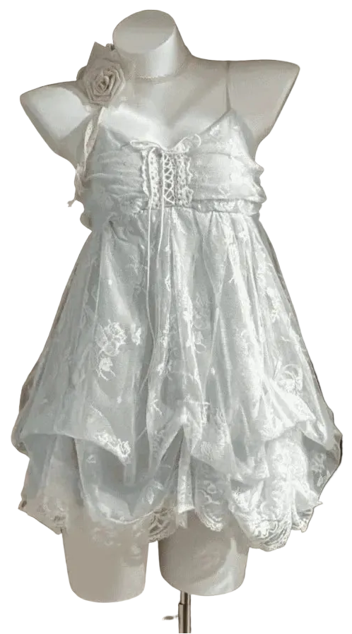 White lace dress on a mannequin against a dark background