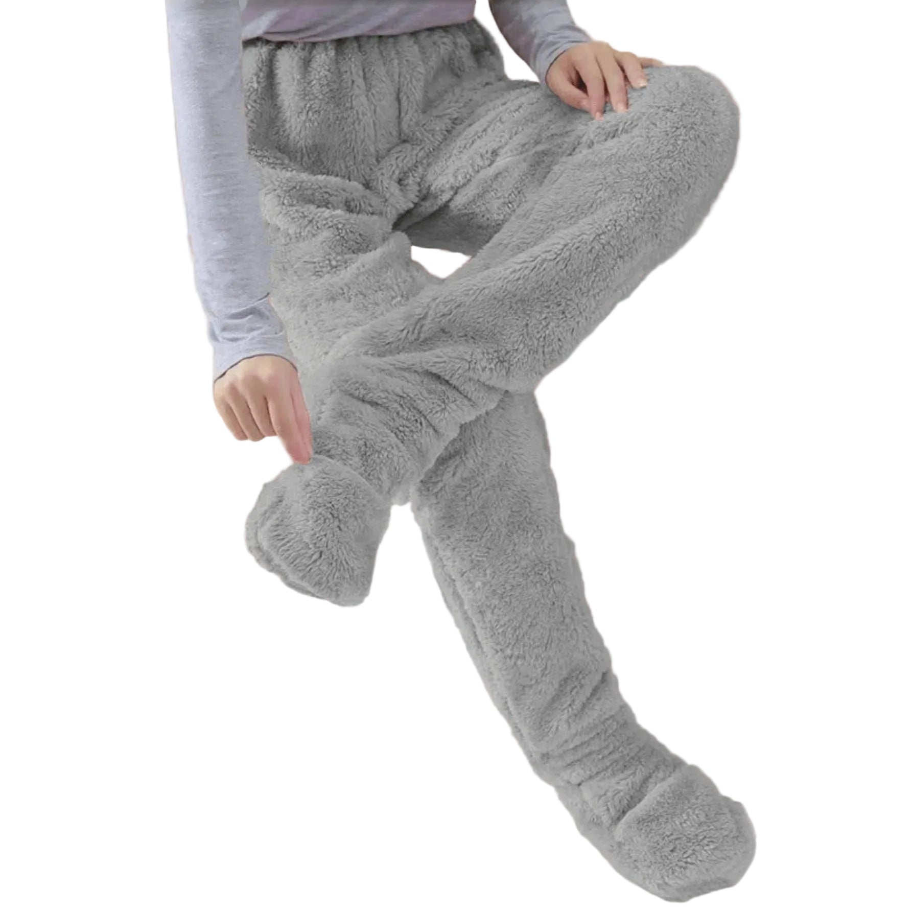 Person wearing gray fuzzy lounge pants sitting on a beige couch.