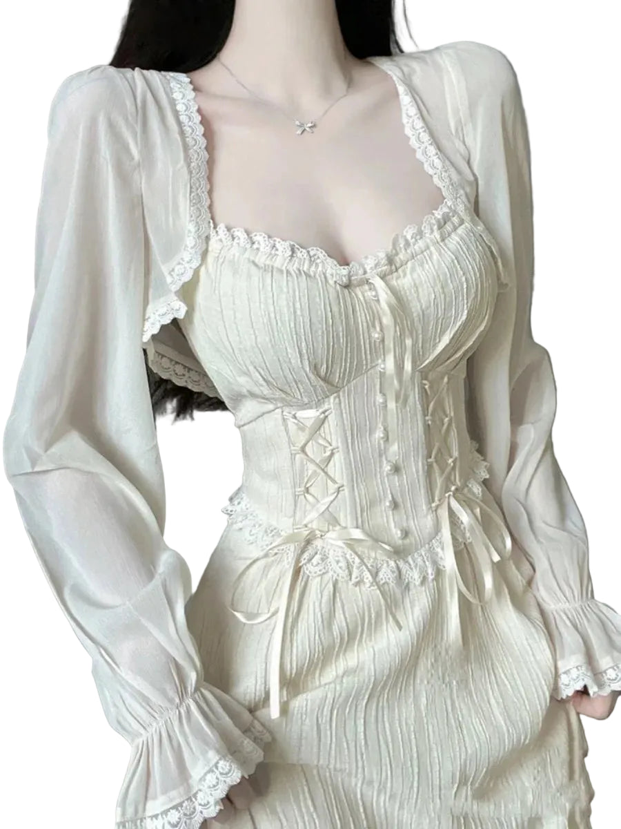 White lace dress with sheer overlay on a neutral background