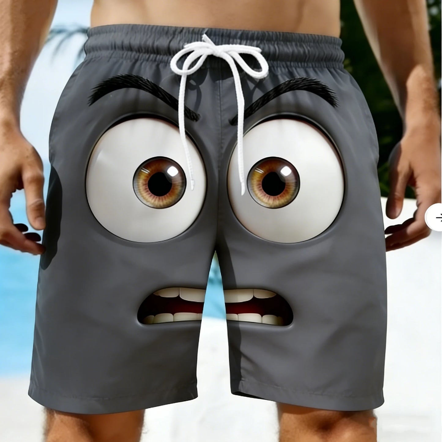Gray shorts with cartoonish face design on a beach background
