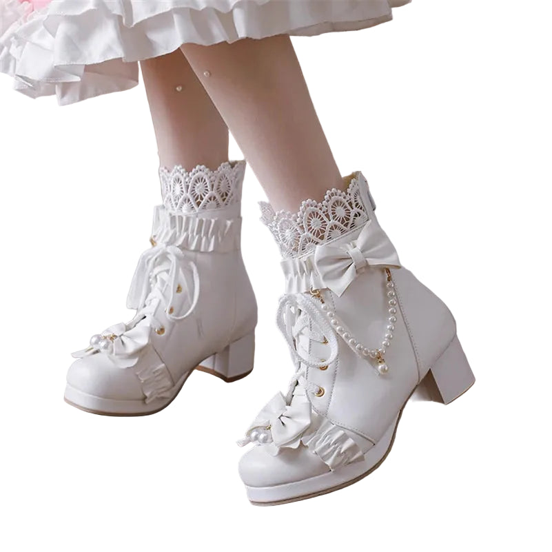 White lace-up boots with decorative elements on a wooden floor.