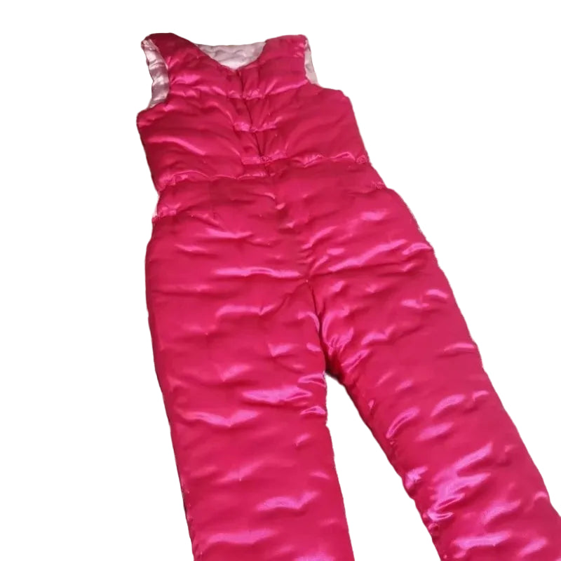 Pink snowsuit on a patterned fabric surface