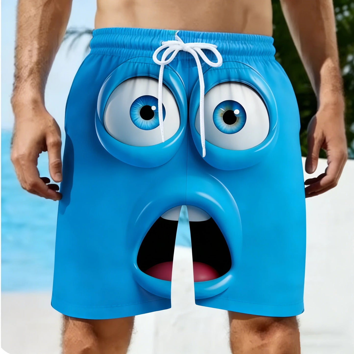 Blue swim shorts with a cartoonish face design on a beach.