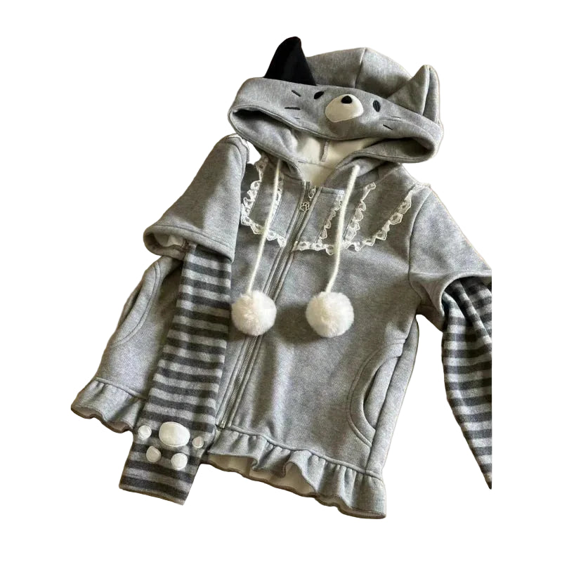 Children's gray hoodie with animal ears and pom-pom details on a wooden floor.