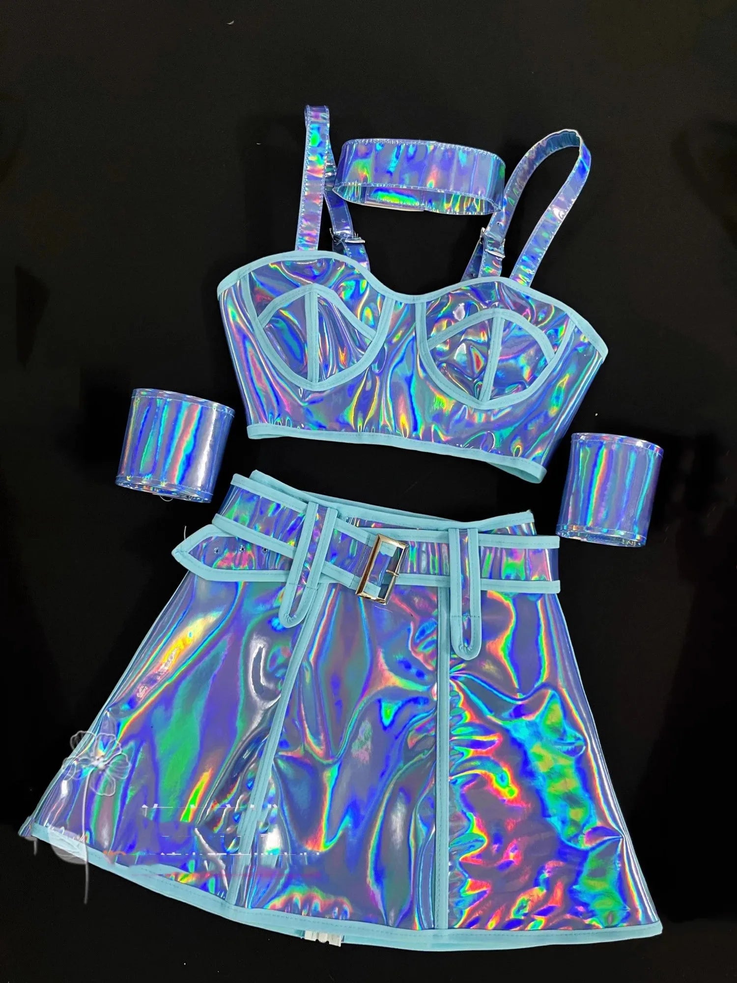 Holographic outfit with bra, top, and skirt on a black background
