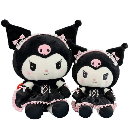 Two black and white plush toys with pink accents on a checkered tablecloth.
