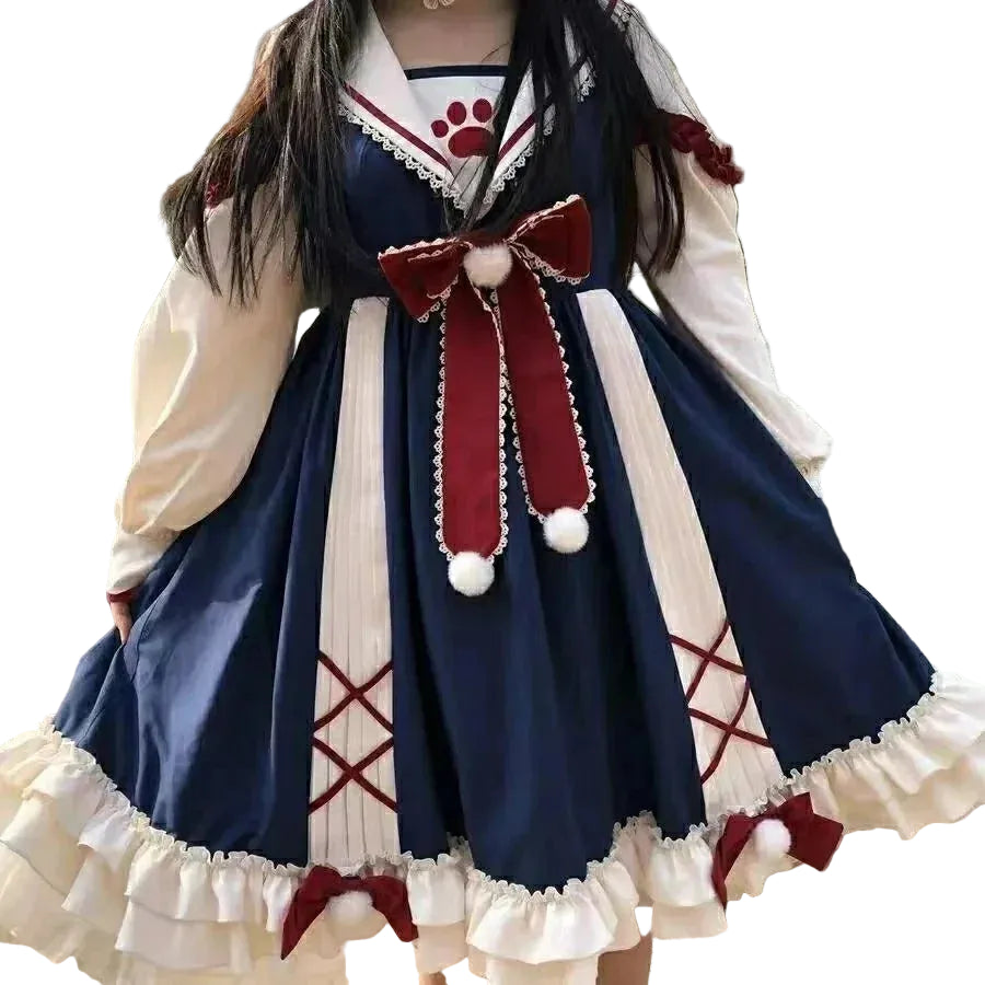 Person wearing a navy and white dress with a large red bow in an outdoor setting.