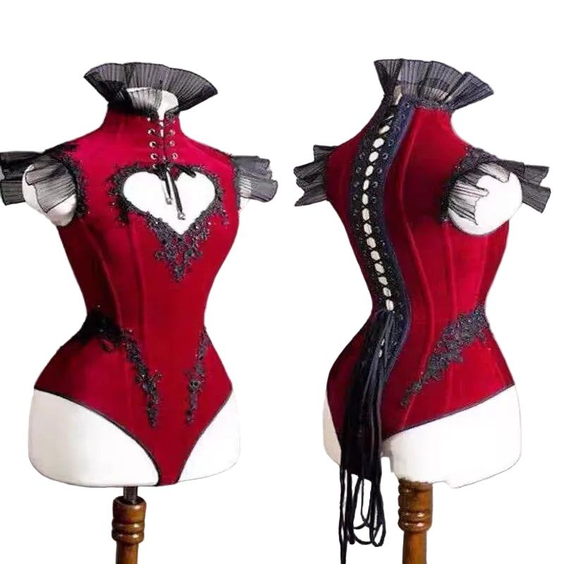 Red corset with black embellishments on a mannequin against a gray background