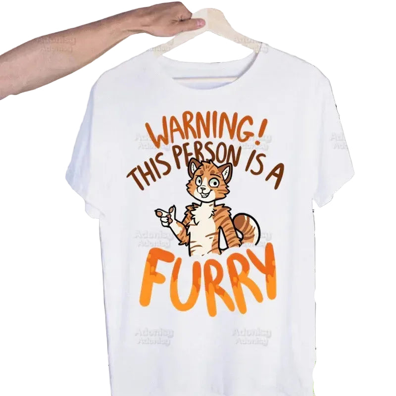 White t-shirt with cartoon fox and text 'Warning! This person is a furry' on a hanger.