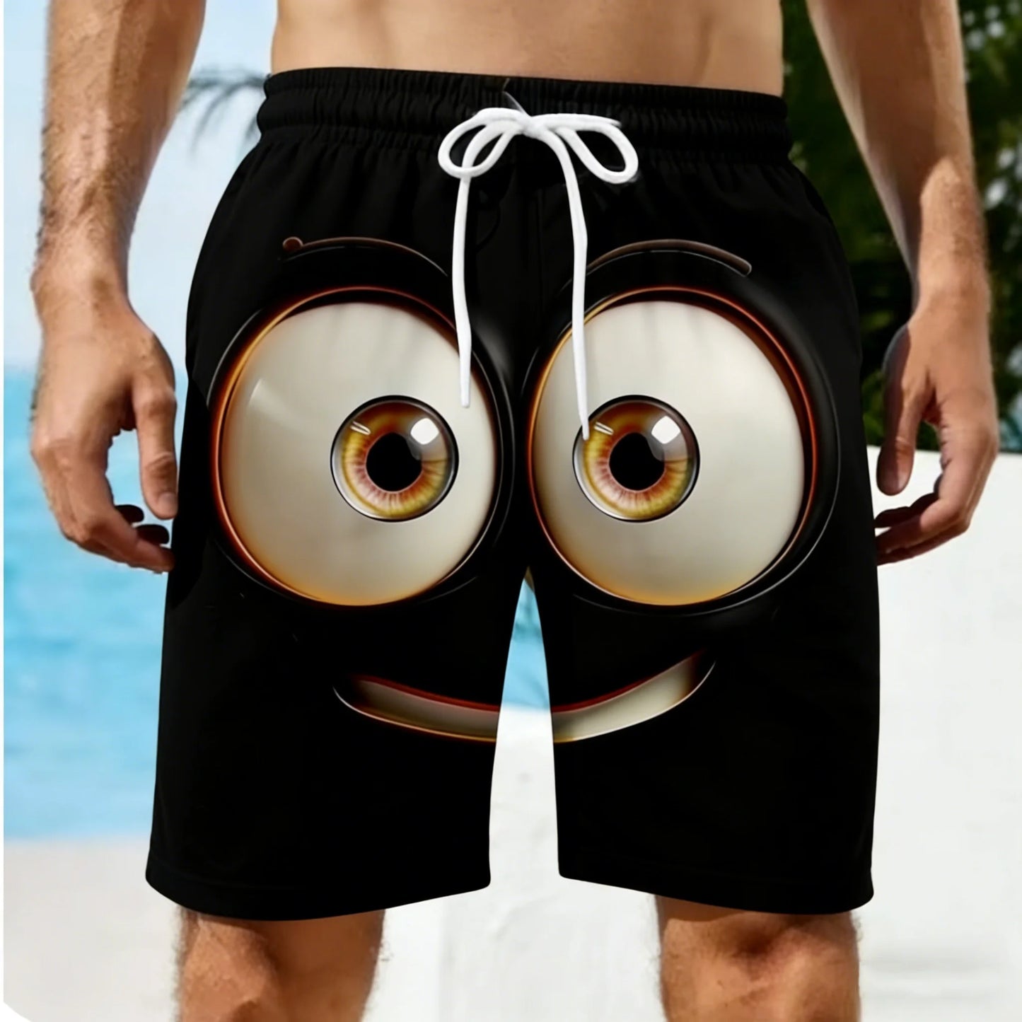 Black shorts with eye design on a beach