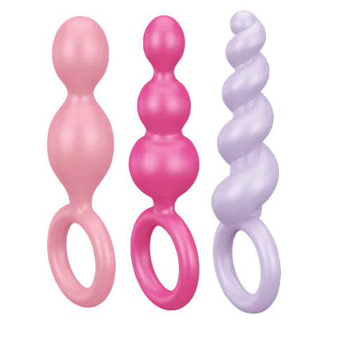 Three pink and white silicone butt plugs with packaging on a blue background, featuring text and branding.