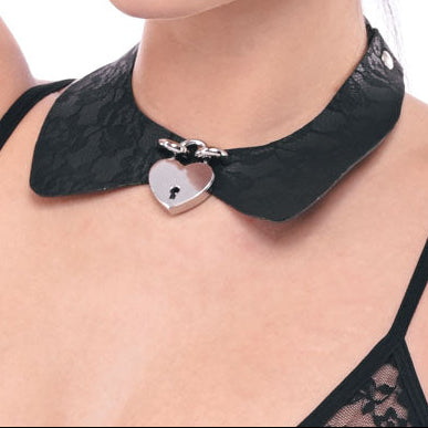 Woman wearing a black lace top with a decorative collar on a white background