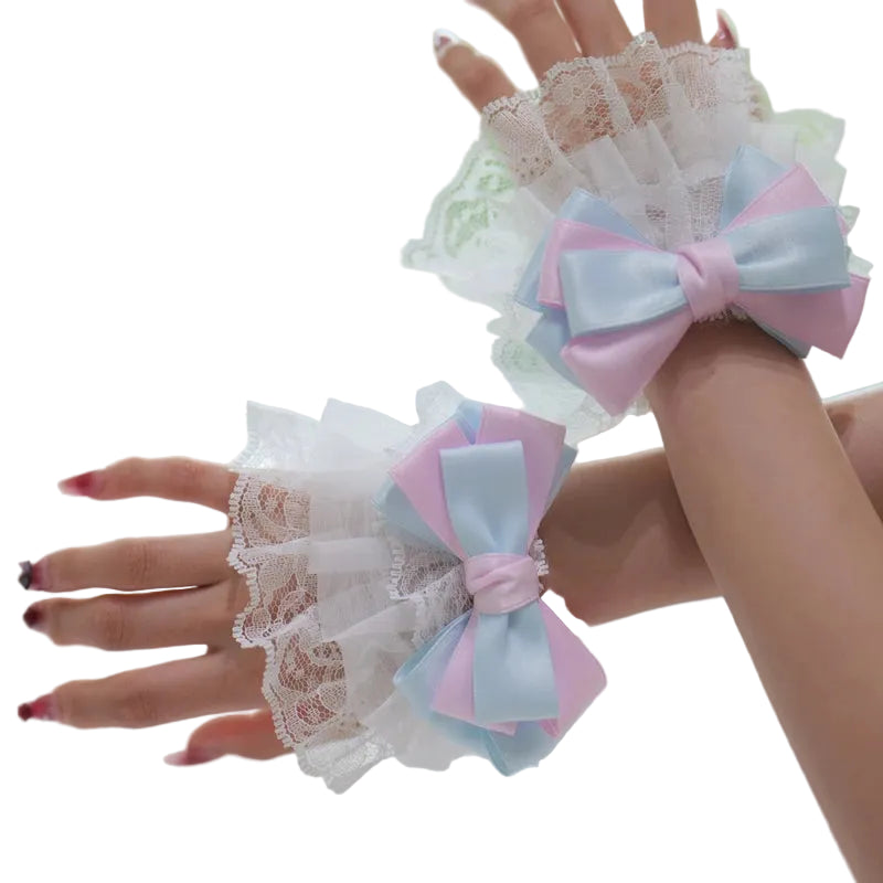 Lace gloves with pink and blue bow decorations on a blurred background