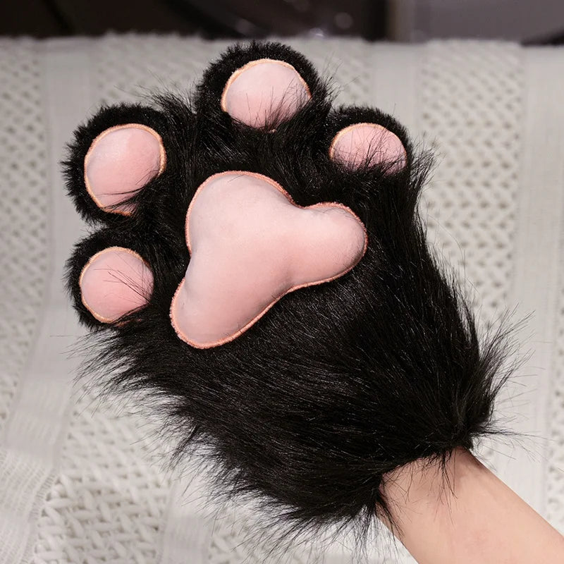 Black paw with pink pads on a textured surface