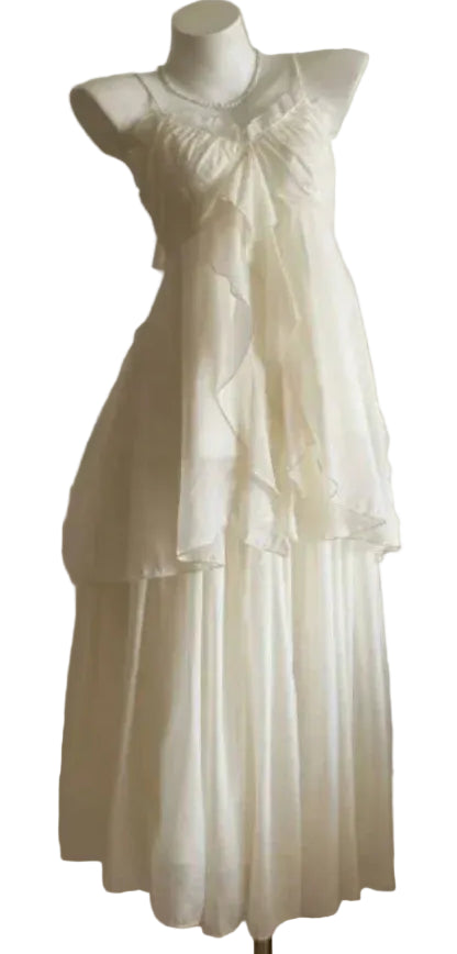 White dress on a mannequin against a plain background
