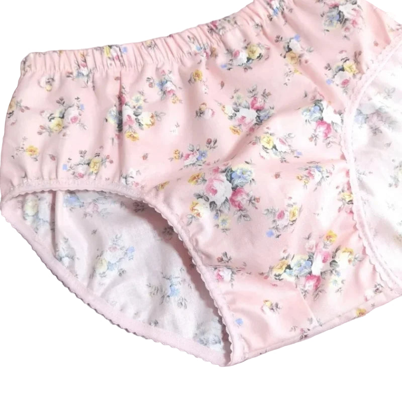 Floral-patterned baby bloomers on a light gray background