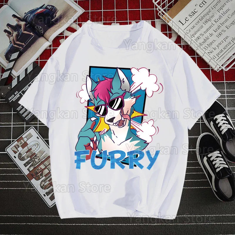 White t-shirt with a colorful graphic of a creature and 'FURRY' text, placed on a grid surface with shoes and a magazine.