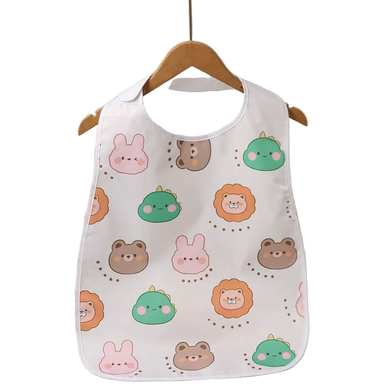 bib with animal pattern hanging on a wooden hanger against a neutral background