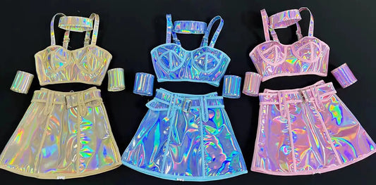 Three holographic outfits with top and skirt sets on a black background