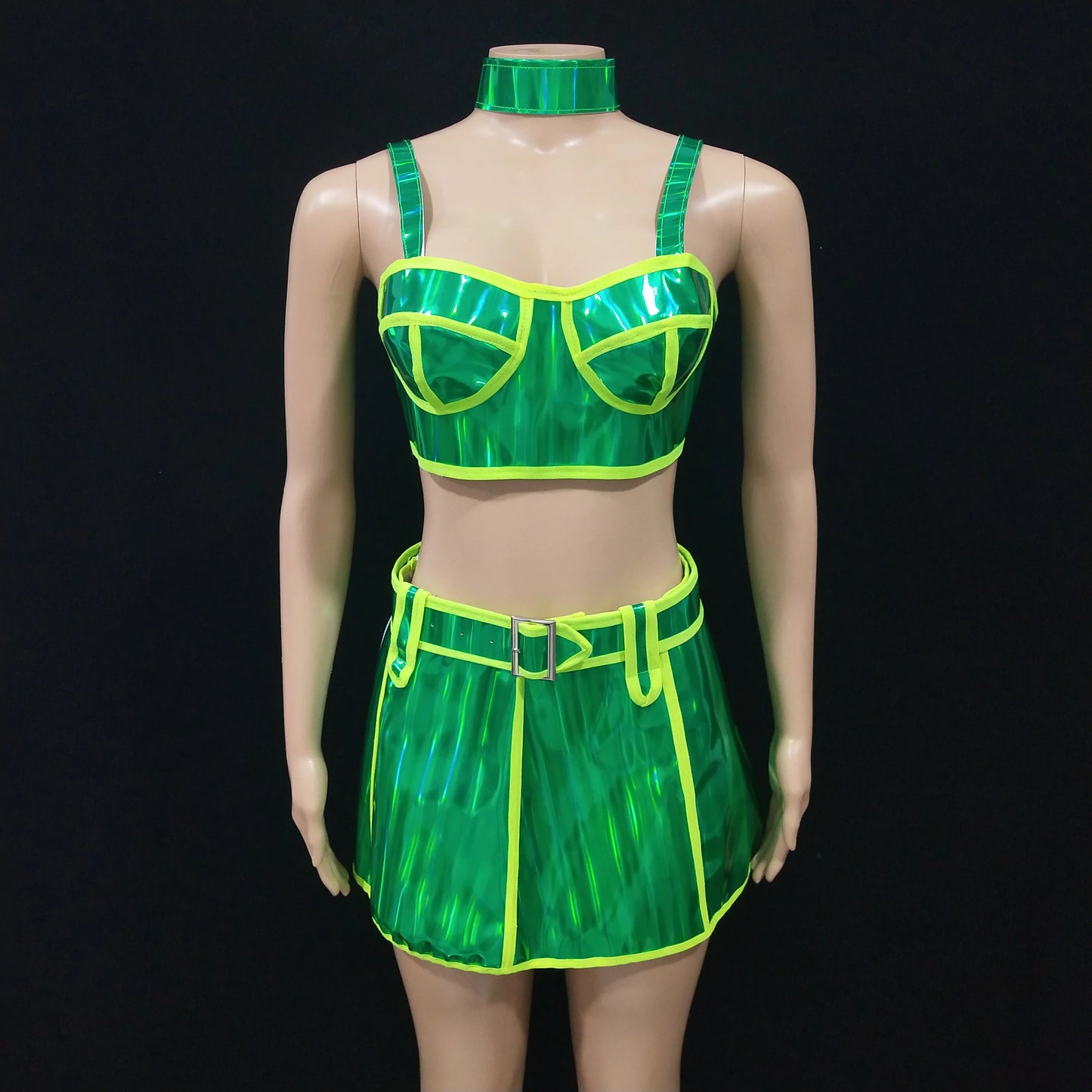 Mannequin wearing a green and yellow outfit with a matching choker on a black background